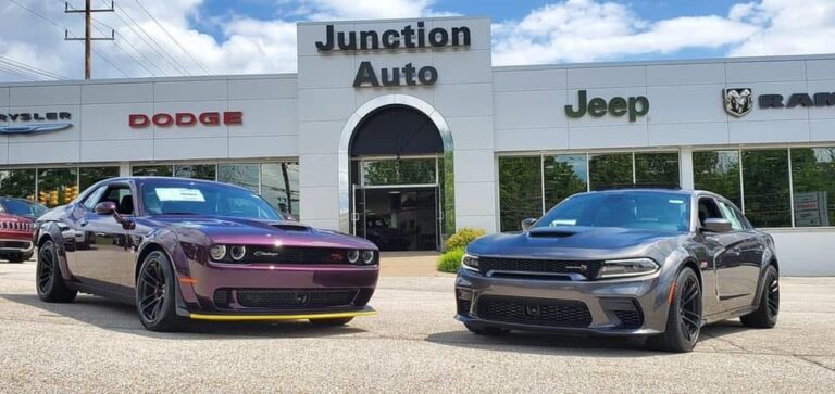 Two Cars Sitting Outside of Junction Auto Family