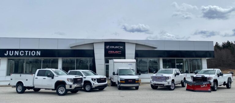 Line of White Vehicles Outside of Junction Auto Family
